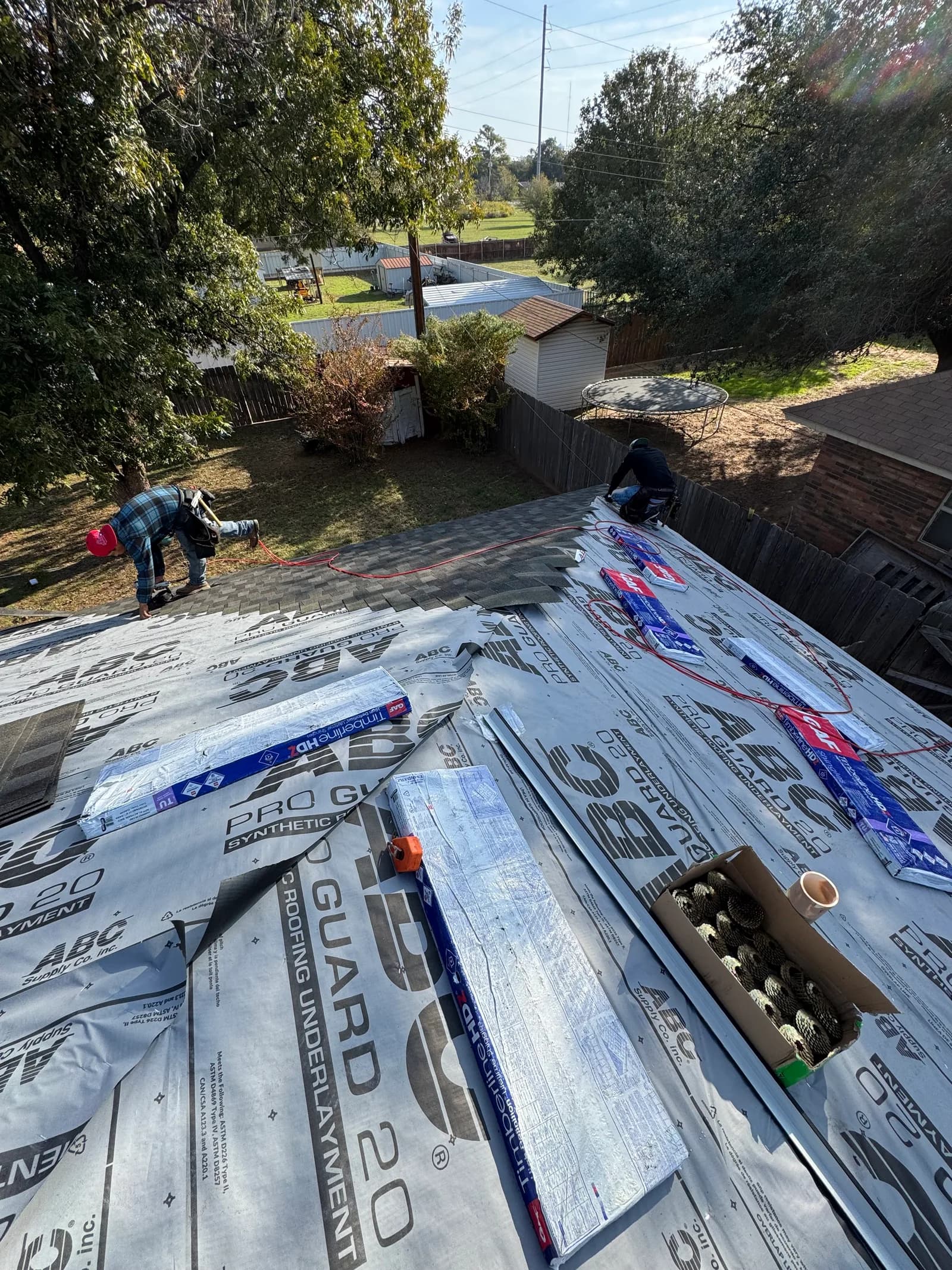 Roofing installation process on a construction site