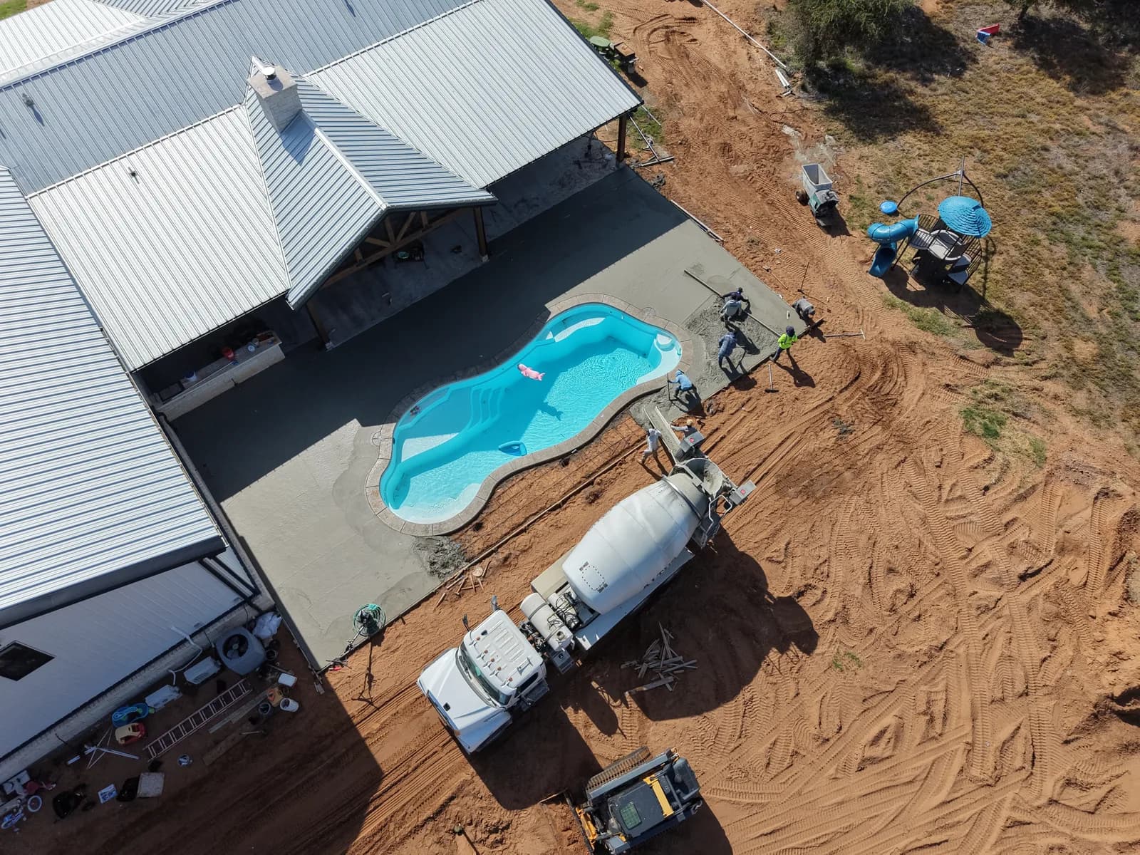 El Dorado Concrete Pool Deck — aerial view of the deck pour wrapping the fiberglass pool in El Dorado, OK