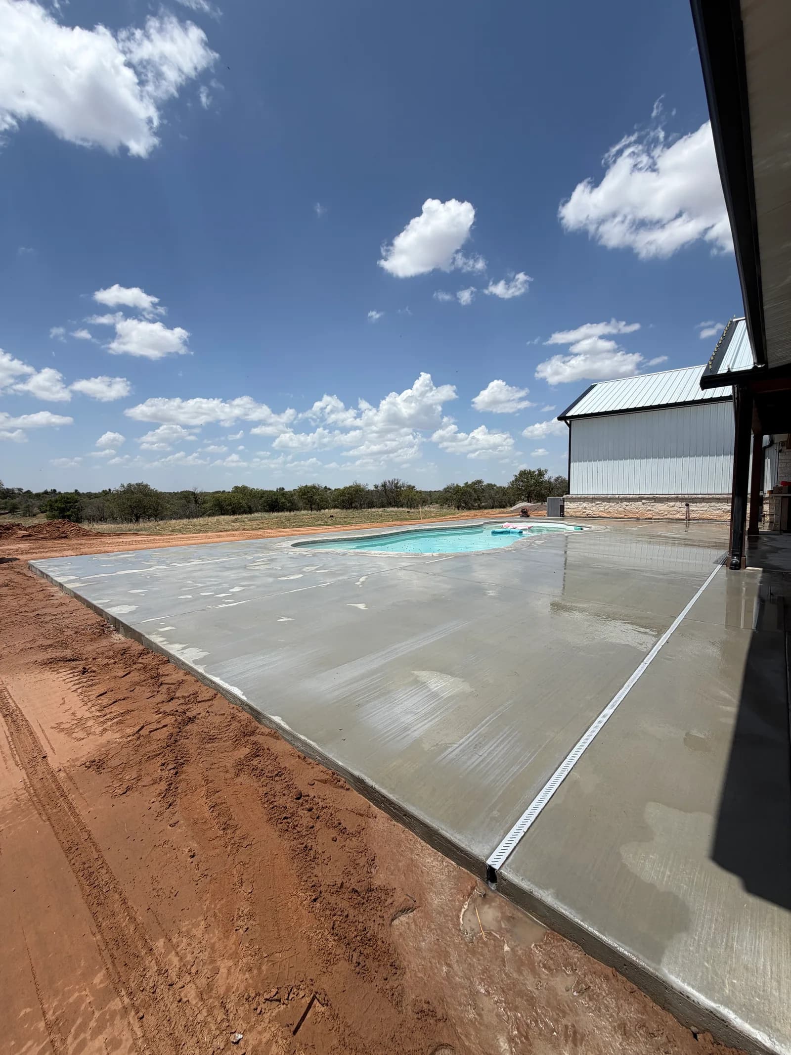 El Dorado Concrete Pool Deck — deck tied into the home's covered patio in El Dorado, OK