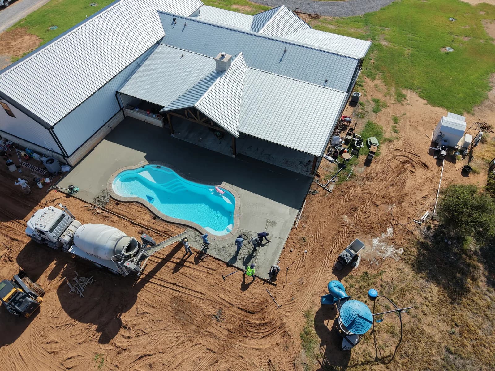 Concrete pool deck poured around a residential pool in El Dorado, OK