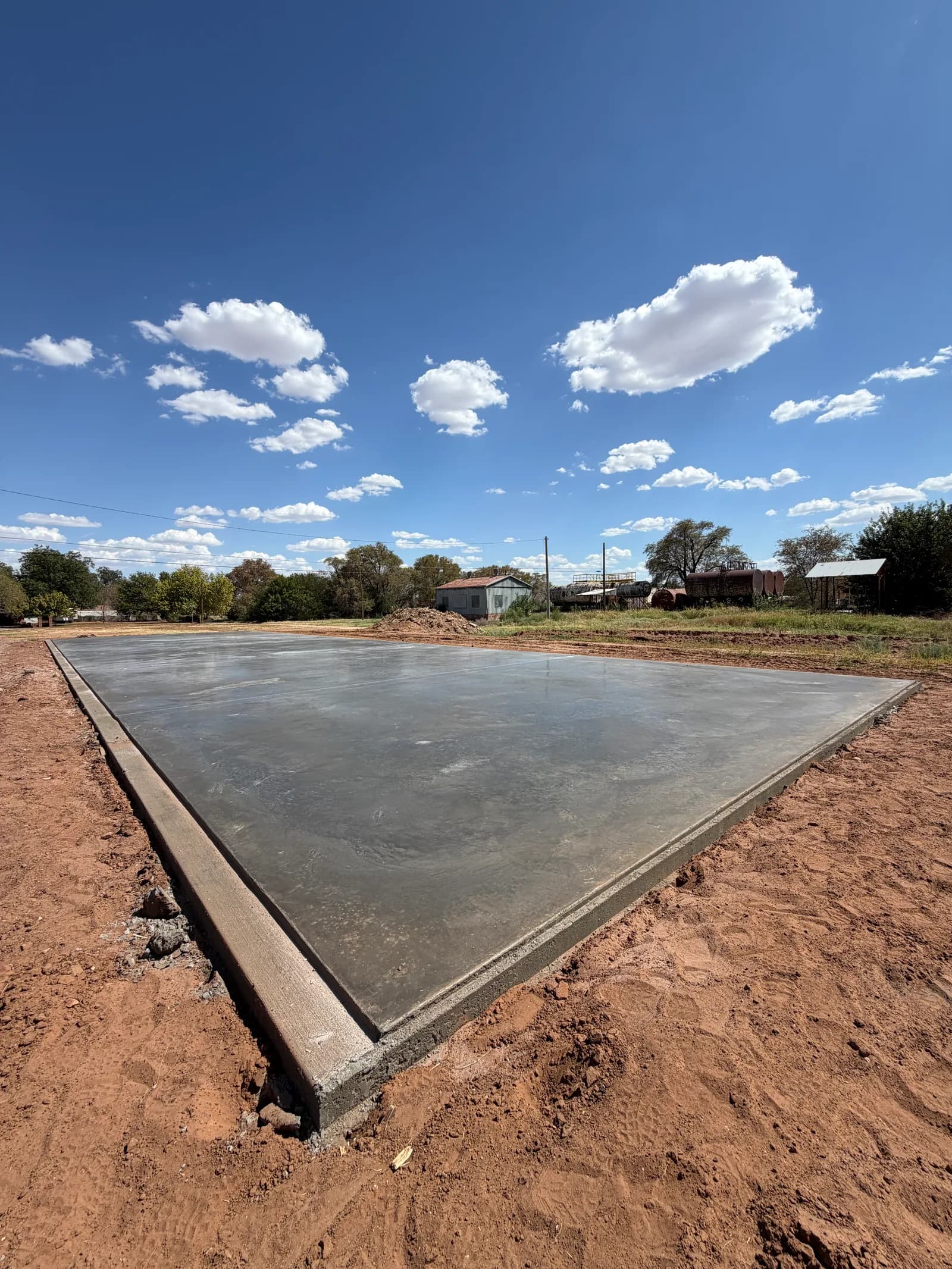 Childress 30' x 100' Storage Building Foundation — continuous slab pour in progress in Childress, TX